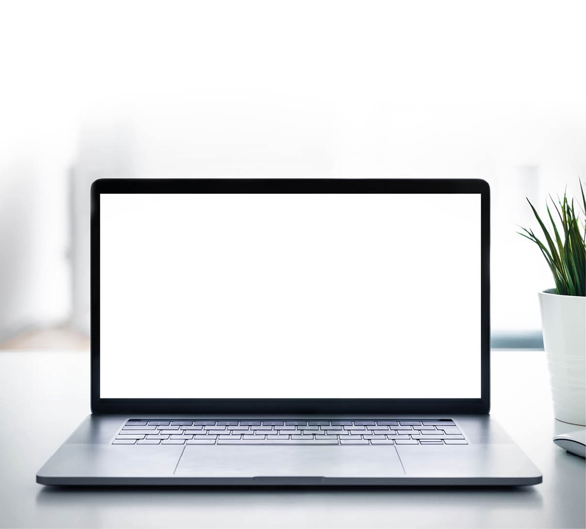 Laptop with blank screen on white table with mouse and smartphone  Home interior or office background