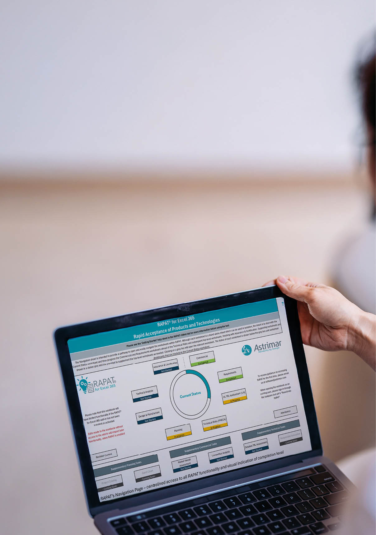 Professional setting showing a laptop screen with graphs and charts presenting data analysis, held by hands in a business context, focusing on modern technology and information within a bright office environment.