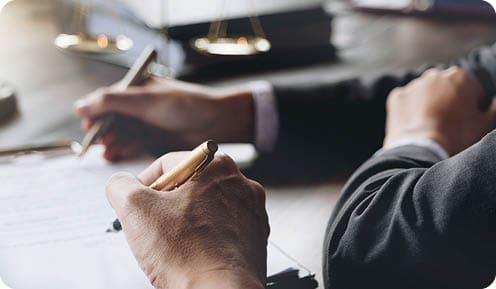 Judge gavel with Justice lawyers having team meeting at law firm in background. Notary with client in office