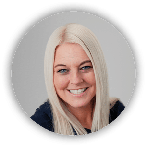 A woman with blonde hair and blue eyes smiling. Description generated by AI