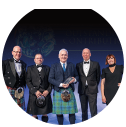 Four men and a woman stand together on a stage. Description generated by AI