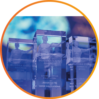 Three clear glass awards with blue lights behind them. Description generated by AI