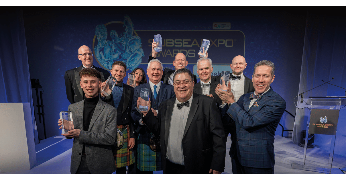 A group of men holding water bottles. Description generated by AI