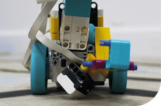 A toy car with a robot face on top of it. Description generated by AI