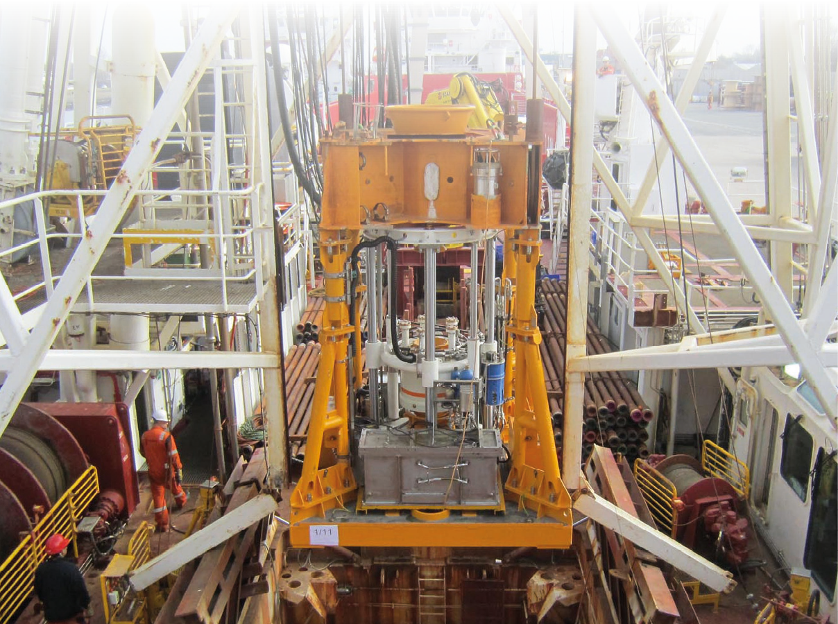 A large yellow machine is on a boat. Description generated by AI