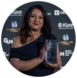 A woman holding a trophy in front of a black background. Description generated by AI