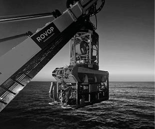A large crane is over the water. Description generated by AI