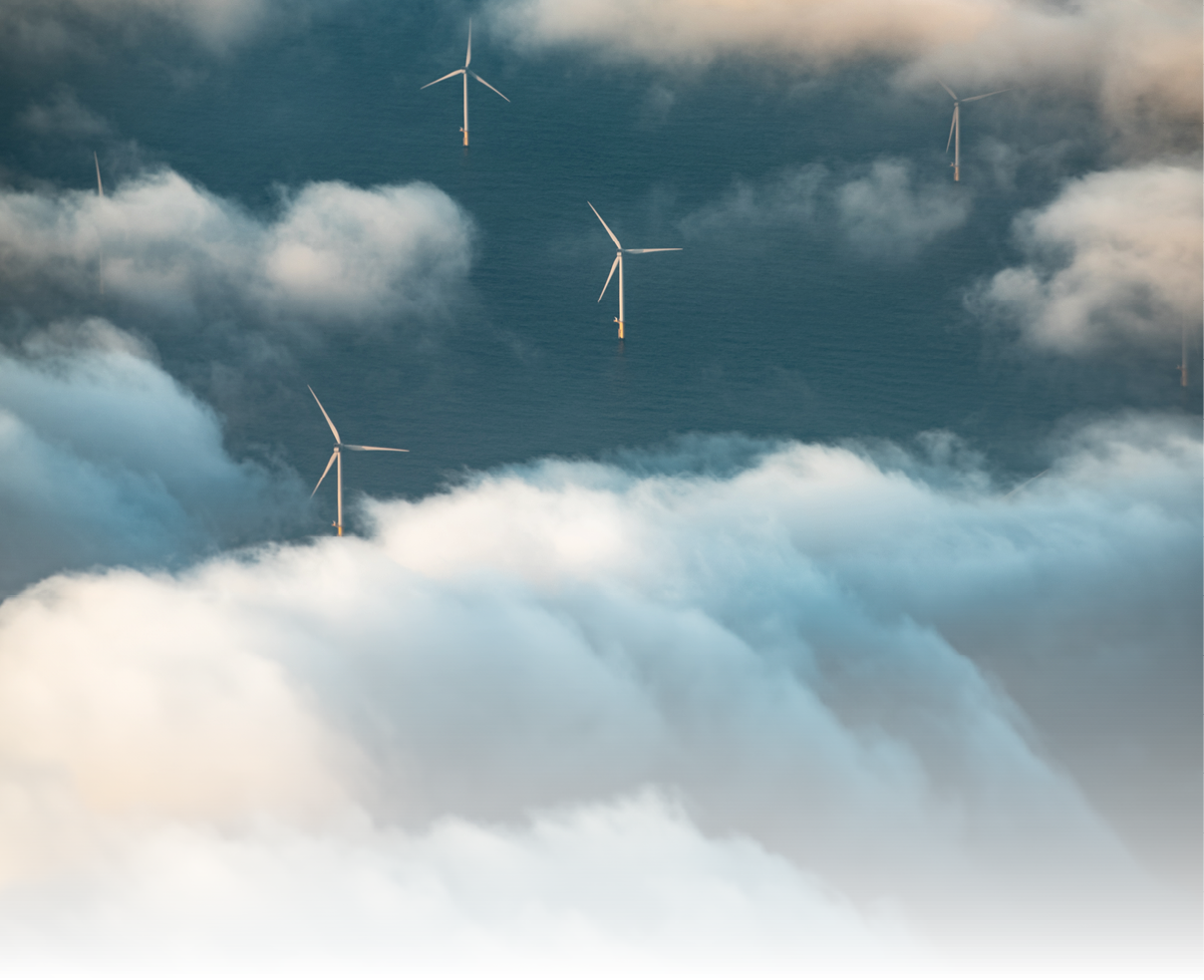 Wind turbines at sea seen with clouds from above